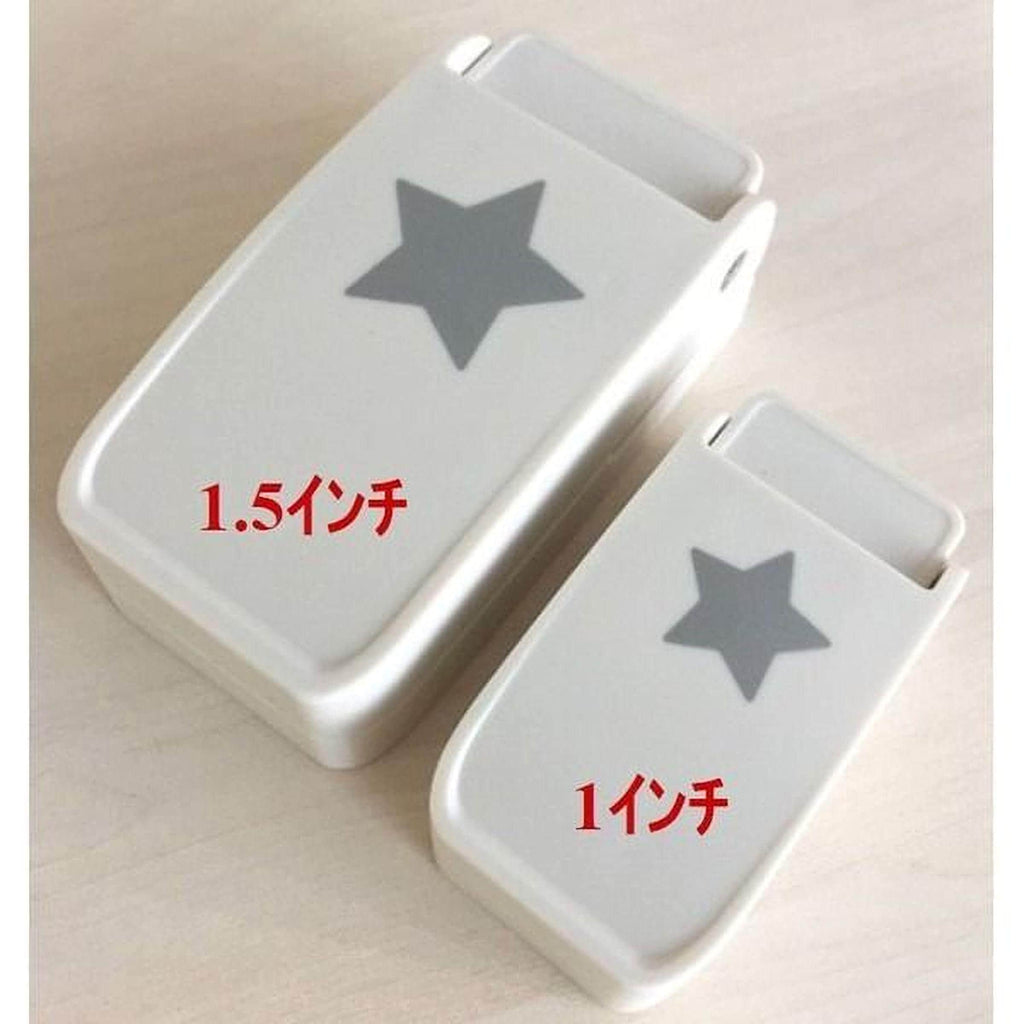 two white objects with a gray star design on them, placed on a light-colored surface.