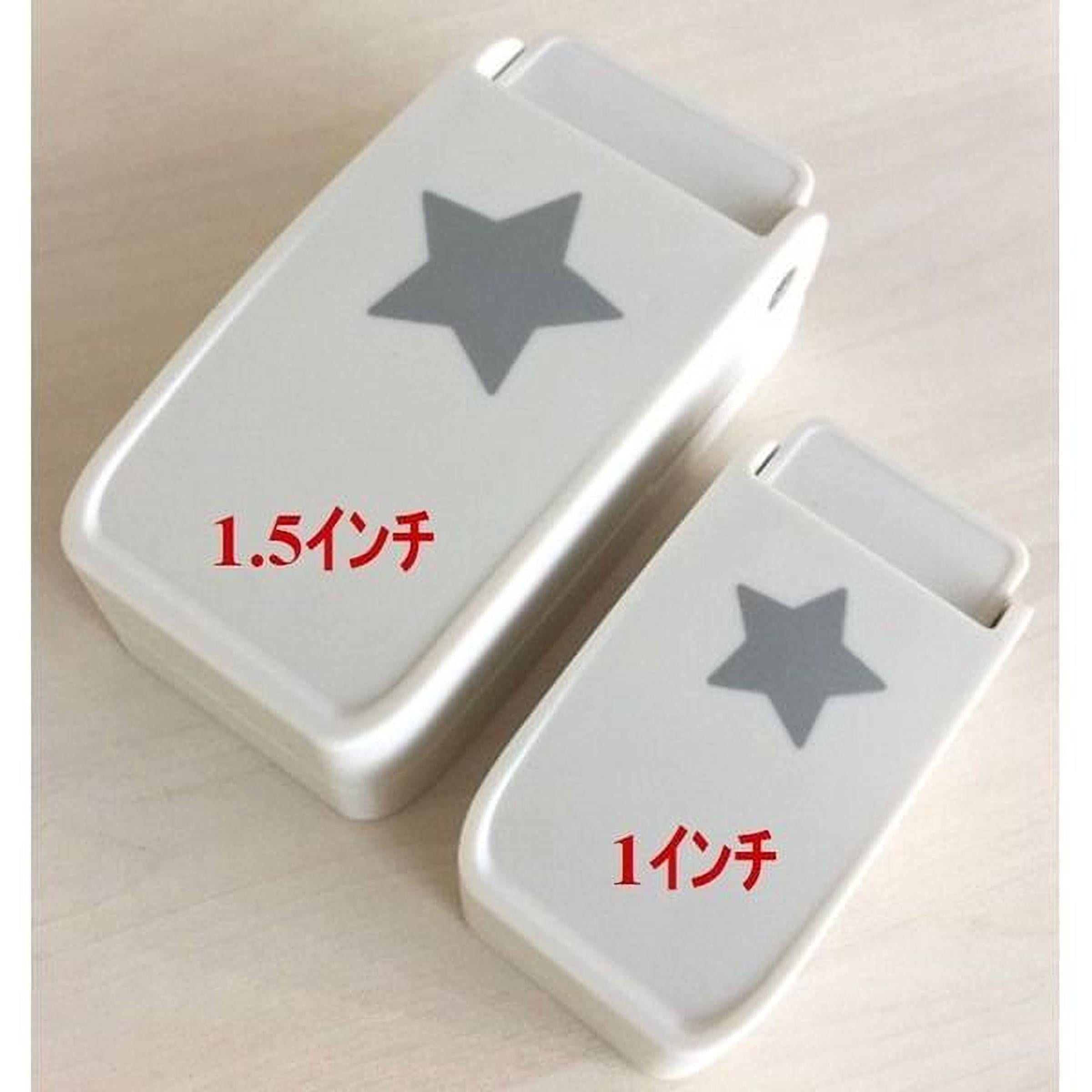 two white objects with a gray star design on them, placed on a light-colored surface.
