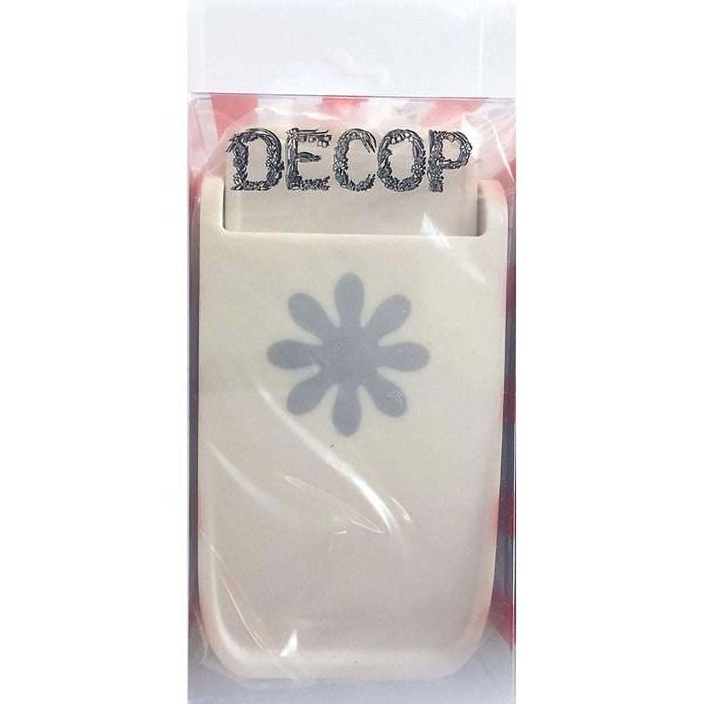 A white plastic tool with a flower-like design on it, which appears to be a hole puncher or similar office supply.