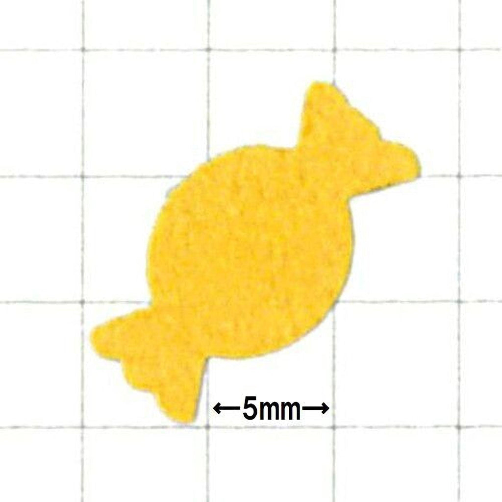 a yellow candy-like object, which appears to be a small, round, and round-shaped object.