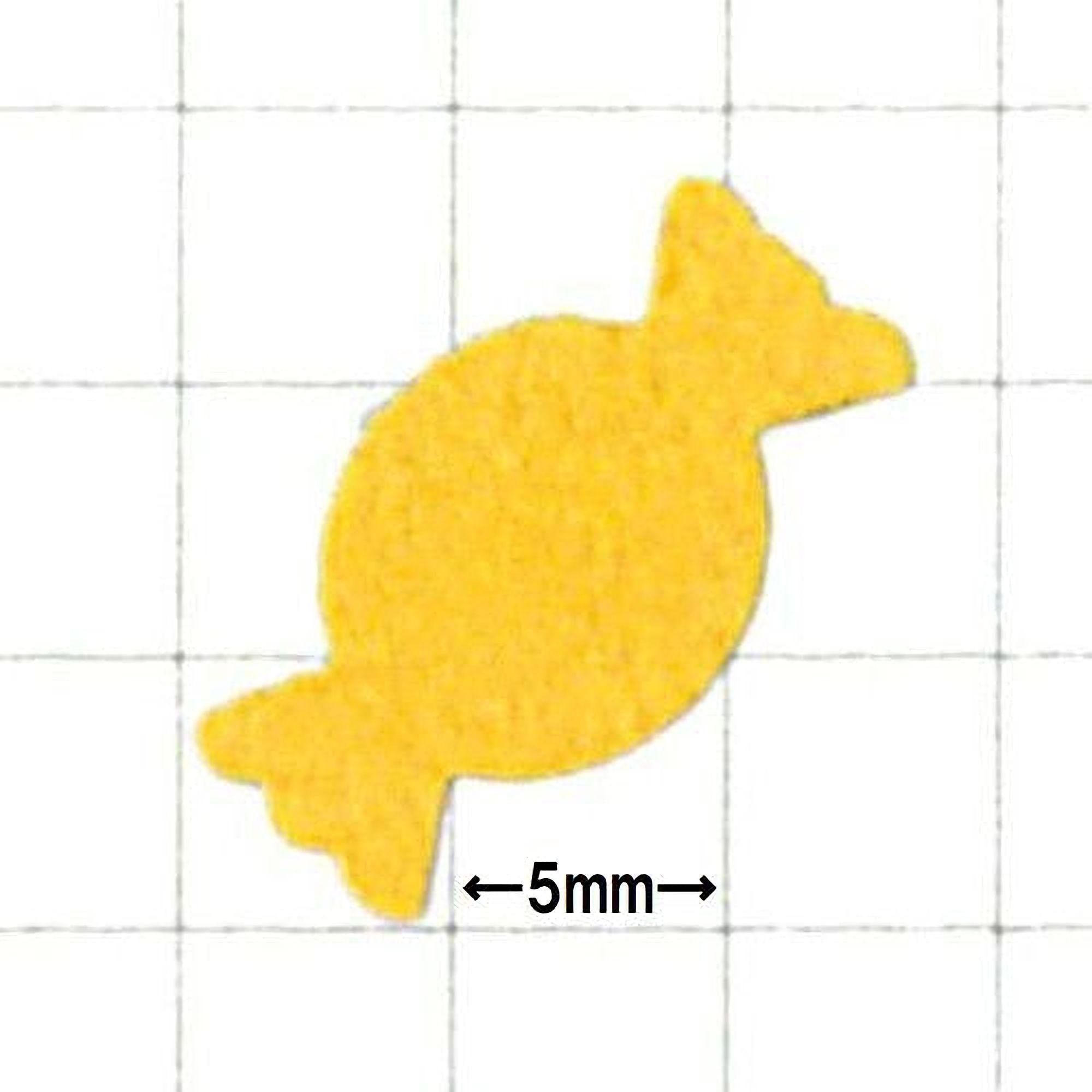 a yellow candy-like object, which appears to be a small, round, and round-shaped object.