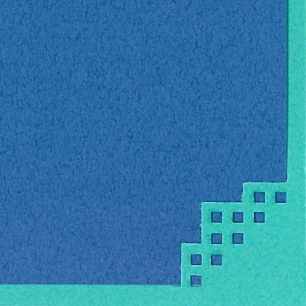 The image is a close-up of a blue and green surface with a geometric pattern of small squares or rectangles.