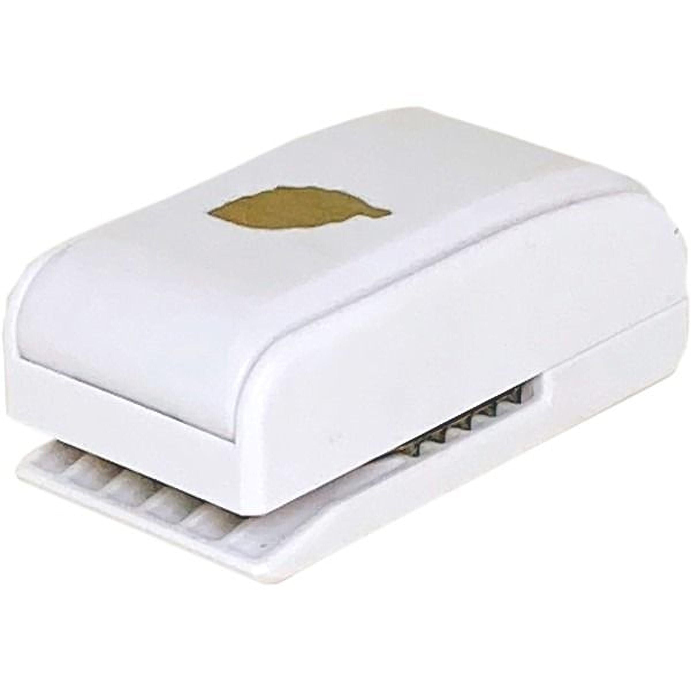 A white paper stapler with a gold leaf design on the top.