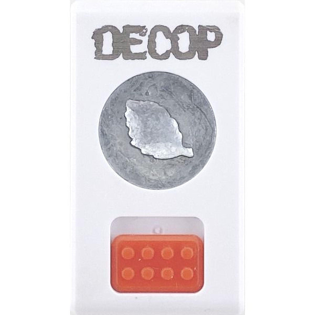 The image is a white rectangular object with a circular cutout in the center, and an orange plastic object below it.