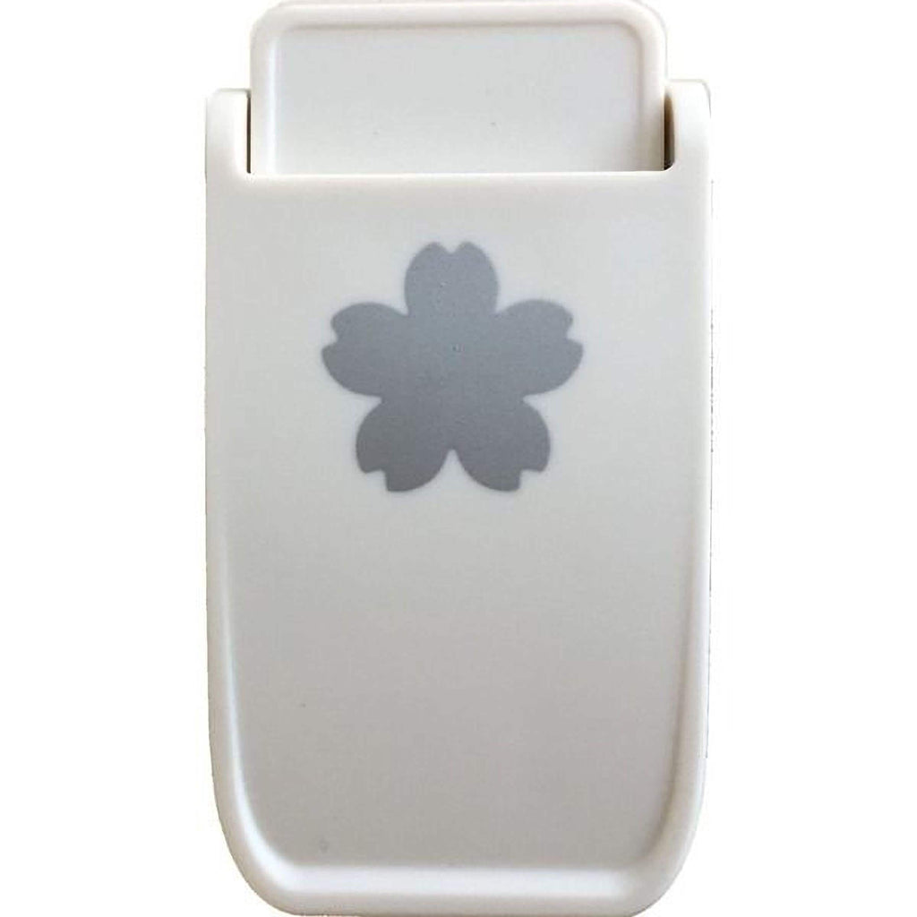 A white plastic object with a gray flower-shaped design on it.