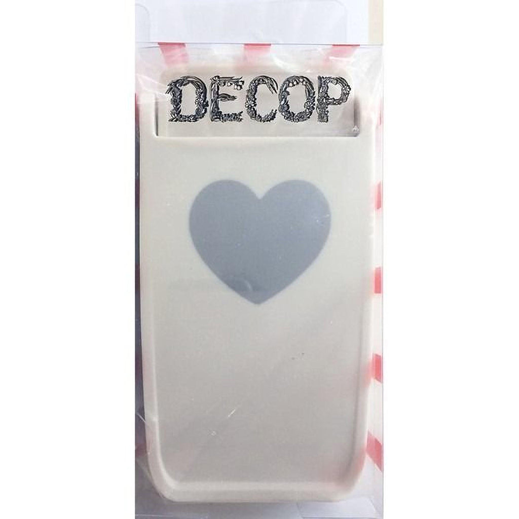 a white object with a heart-shaped cutout in the center, and the word "DECOP" written on the top of the object.