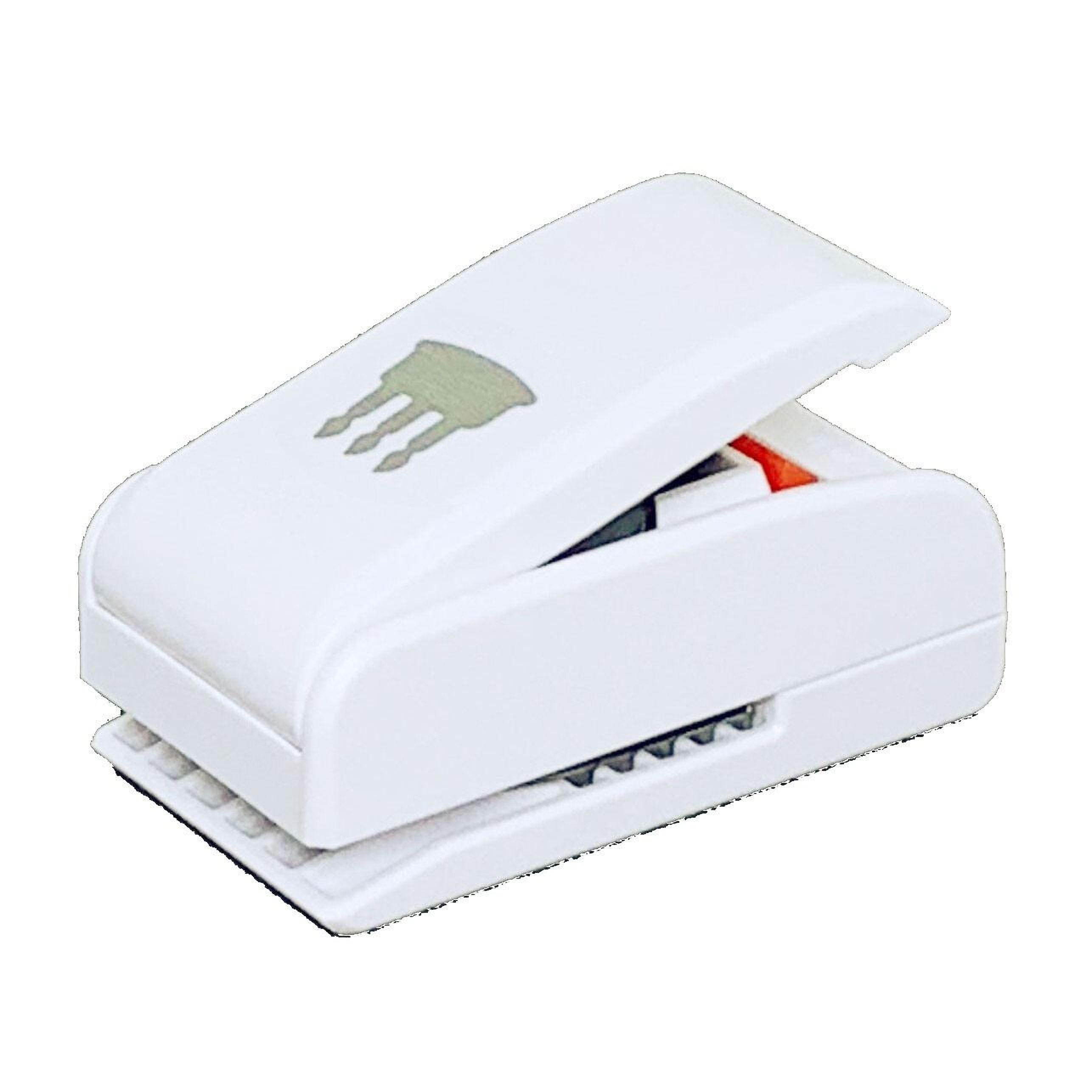 A white stapler with a green design on it.