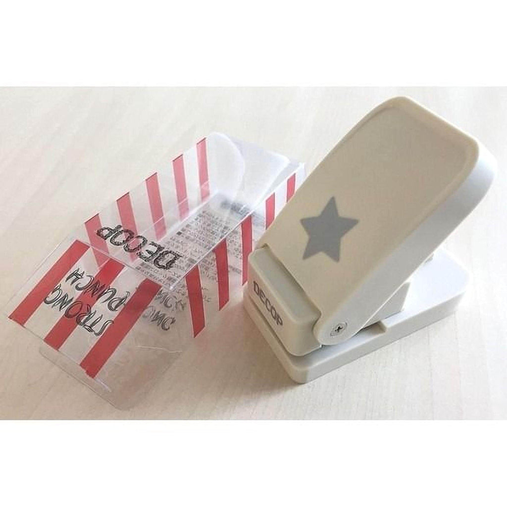 A white plastic punch with a star design on it, placed on a white surface.