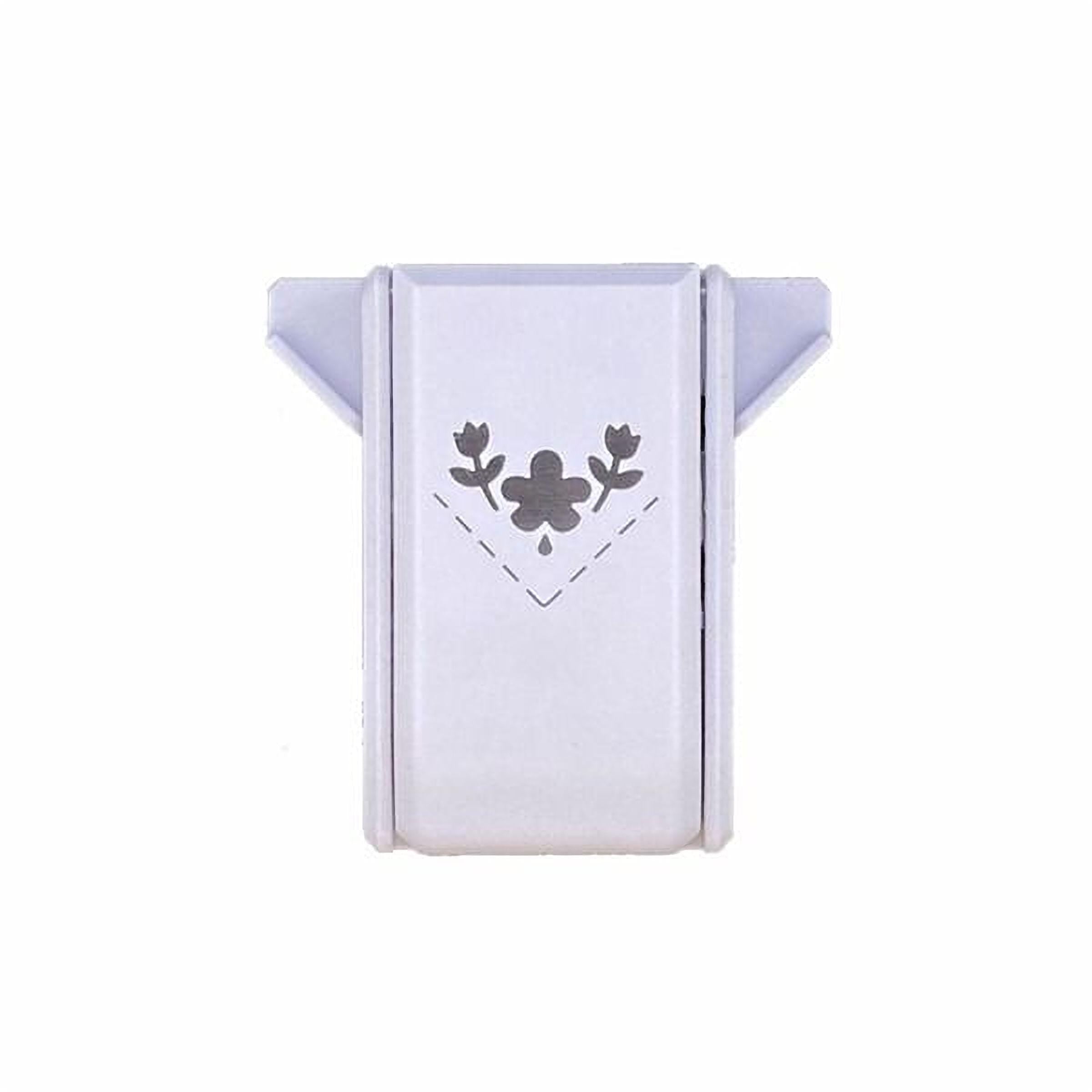A white, rectangular object with a black floral design on it.