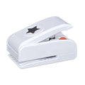 A white plastic hole puncher with a star-shaped hole on the top.