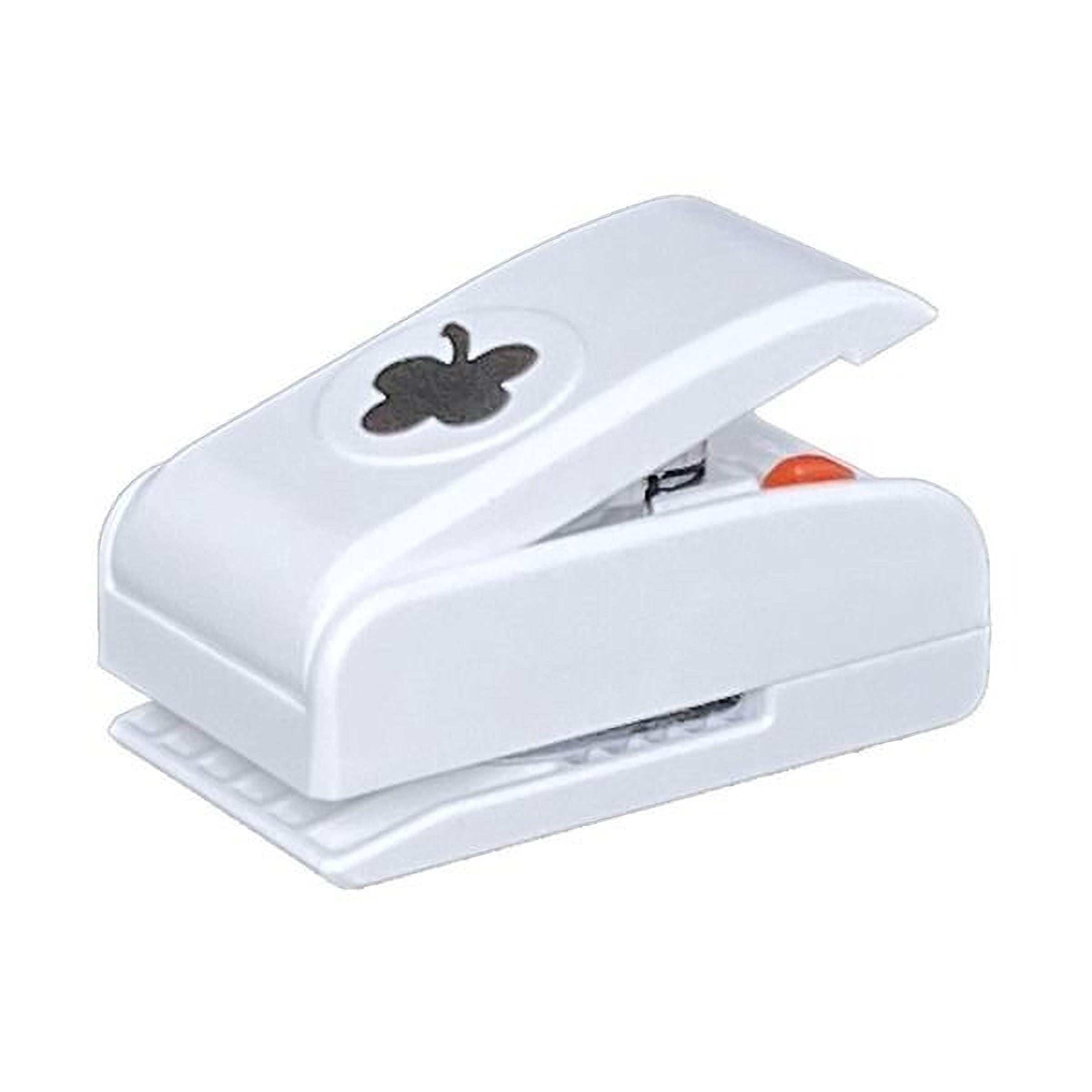 A white plastic hole puncher with a black clover design on it.