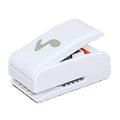 A white plastic hole puncher with a musical note design on it.