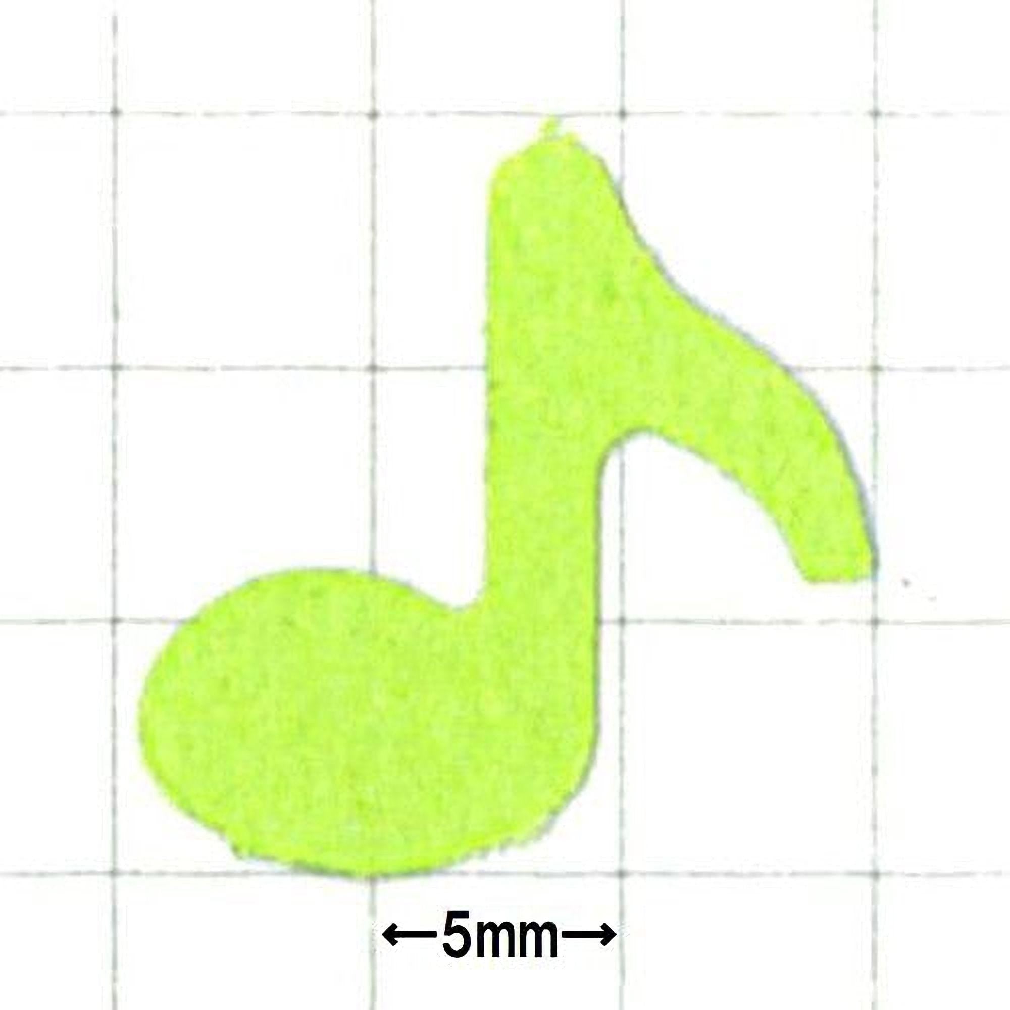 A lime green paper cutout of a musical note is shown against a grid background.