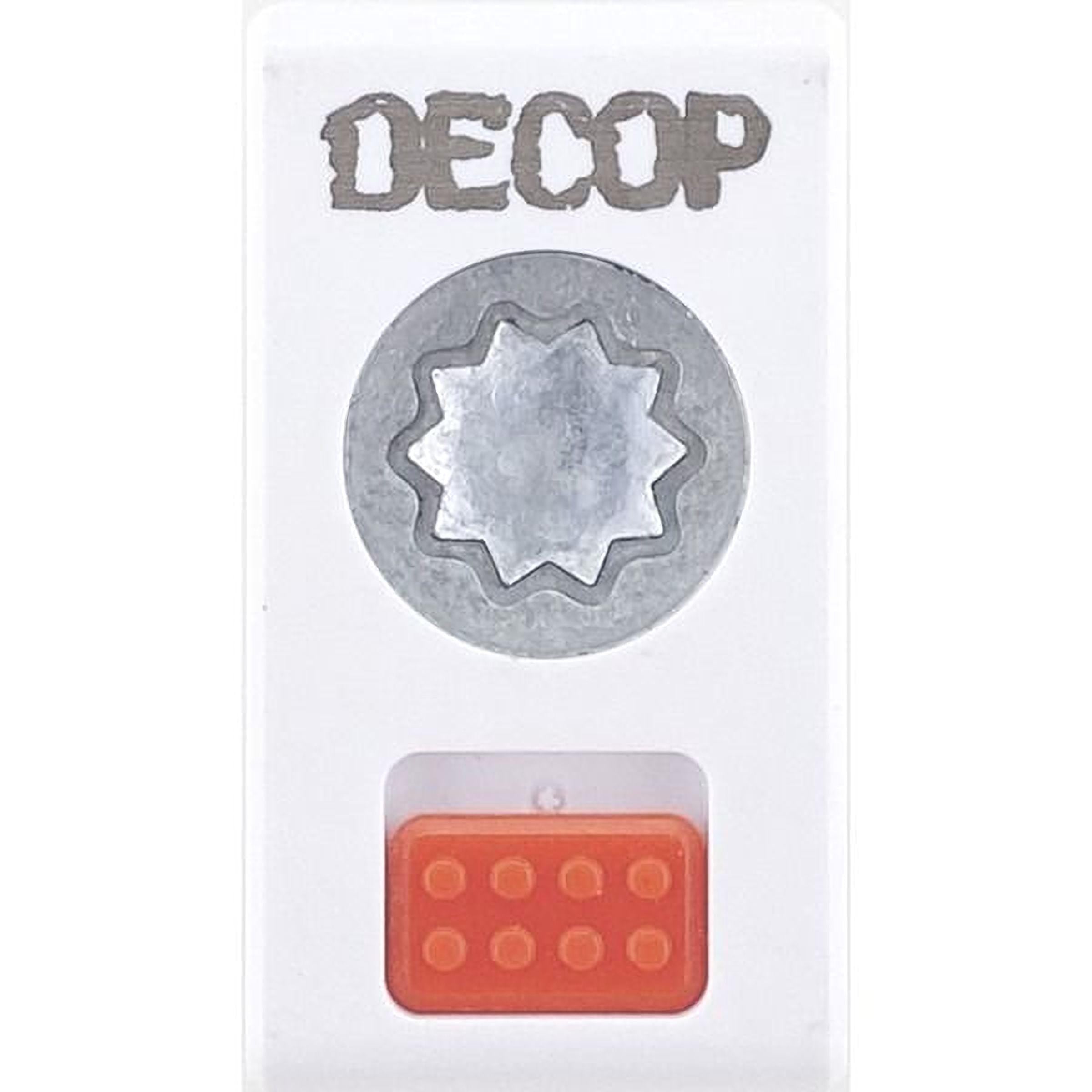 a white object with the word "DECOP" written on it, along with a silver star-shaped object and an orange object below it.