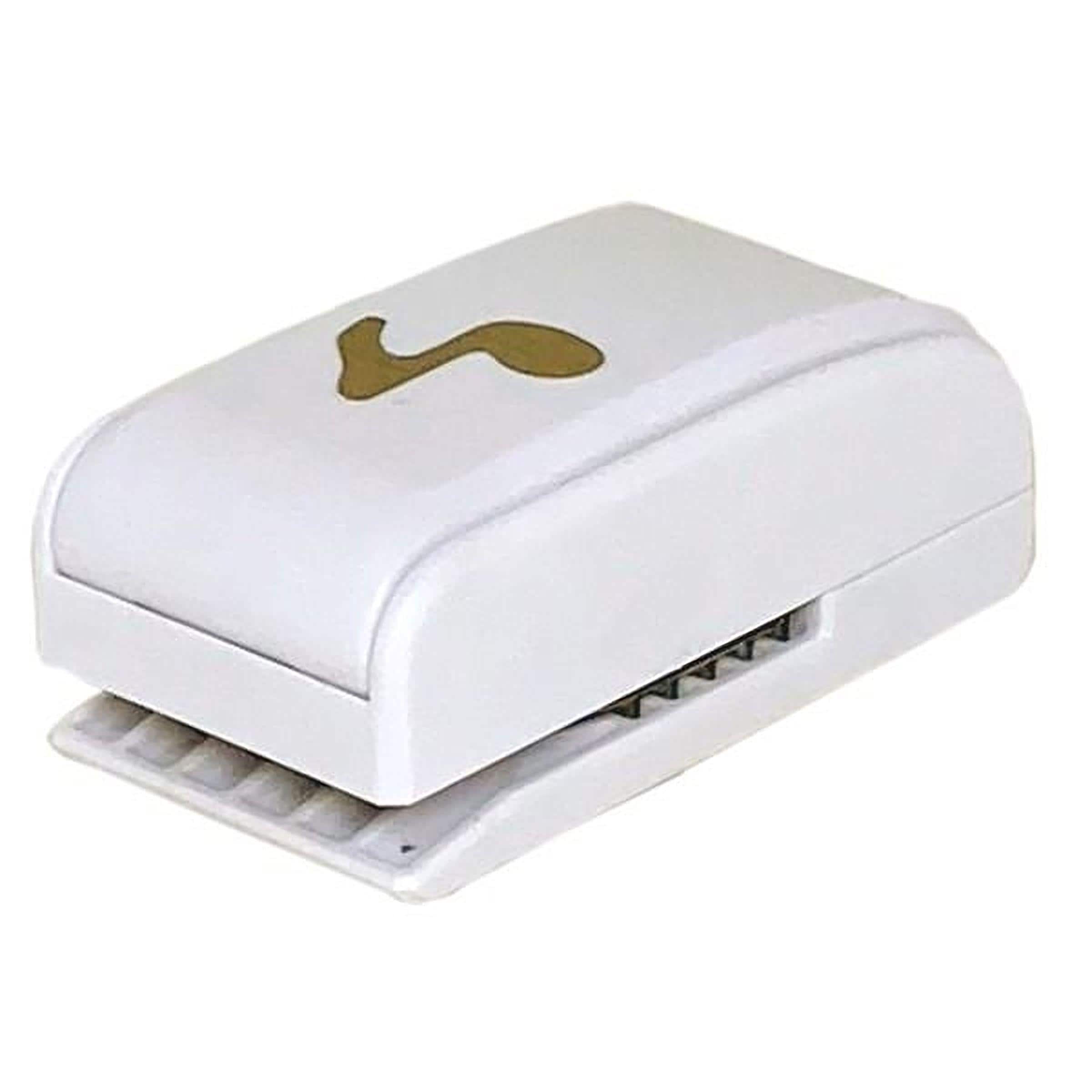 A white and gold stapler with a single staple in the center.