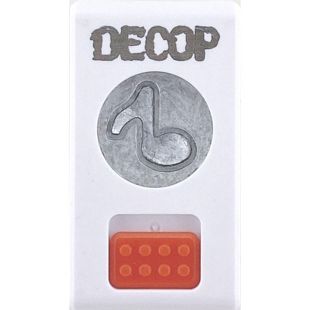 a white object with the word "DECOP" written on it, along with a circular cutout of a musical note. Below the cutout, there is an orange object with a red square on it.