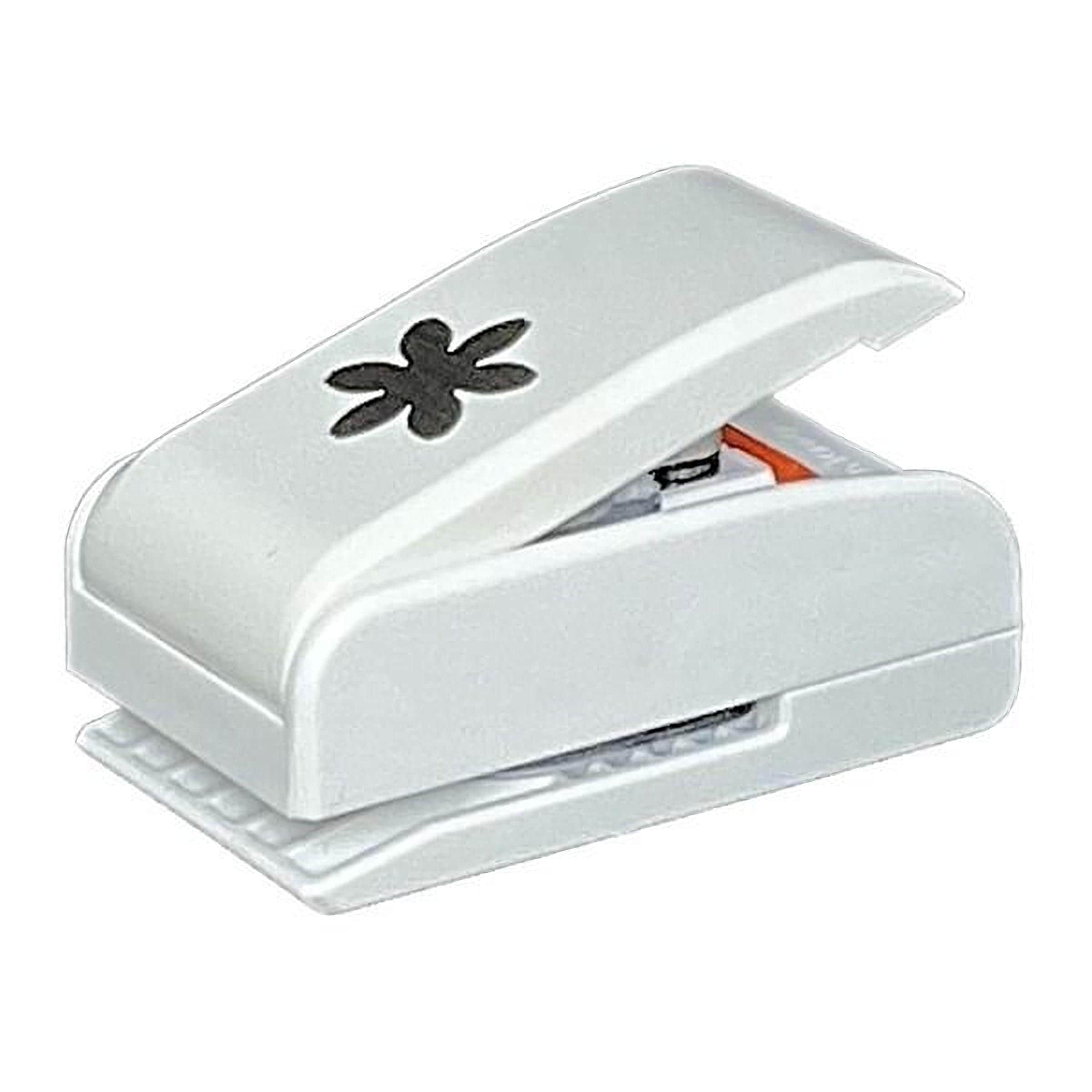 A white plastic hole puncher with a black flower design on the top.