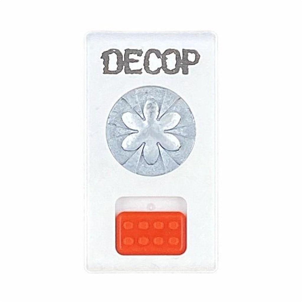The image is a white rectangular object with the word "DECOP" written on it in a stylized font. Below the word "DECOP", there is a circular design featuring a flower-like pattern. The object also has an orange button on the bottom right side.