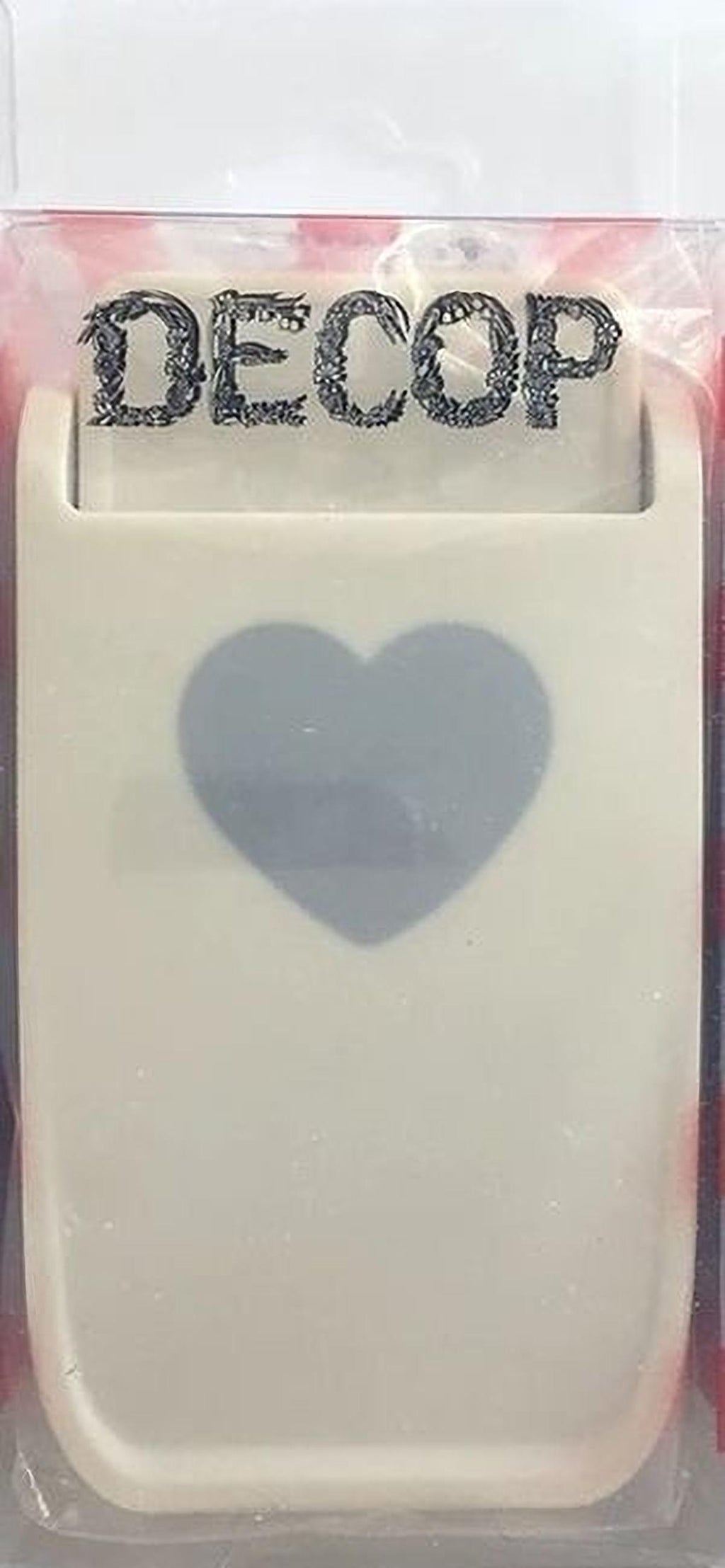 a white plastic object with a heart-shaped cutout in the center, and the word "DECOP" written on the top of the object.