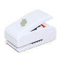 A white plastic hole puncher with a green logo on it.