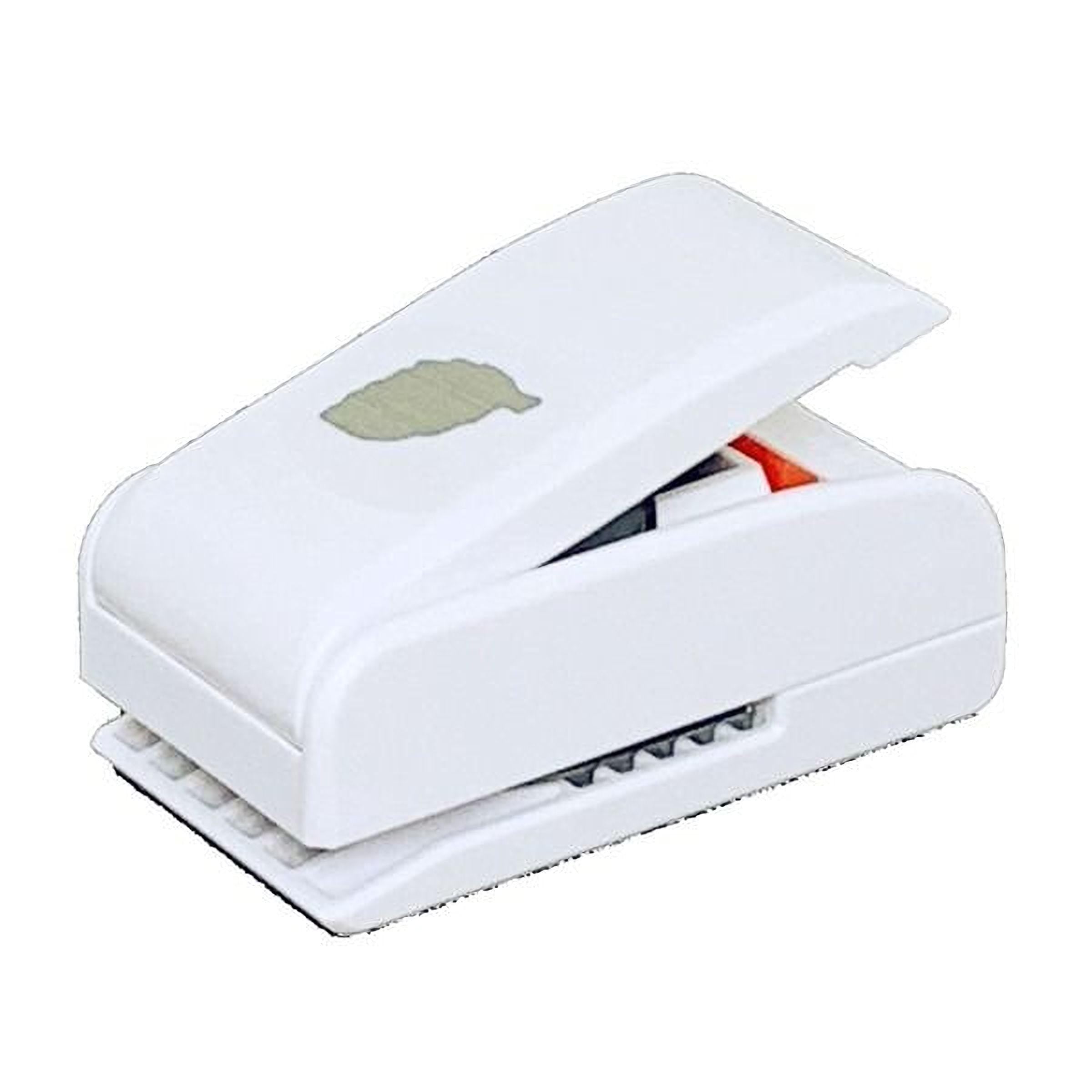 A white, rectangular paper stapler with a green leaf design on the top.