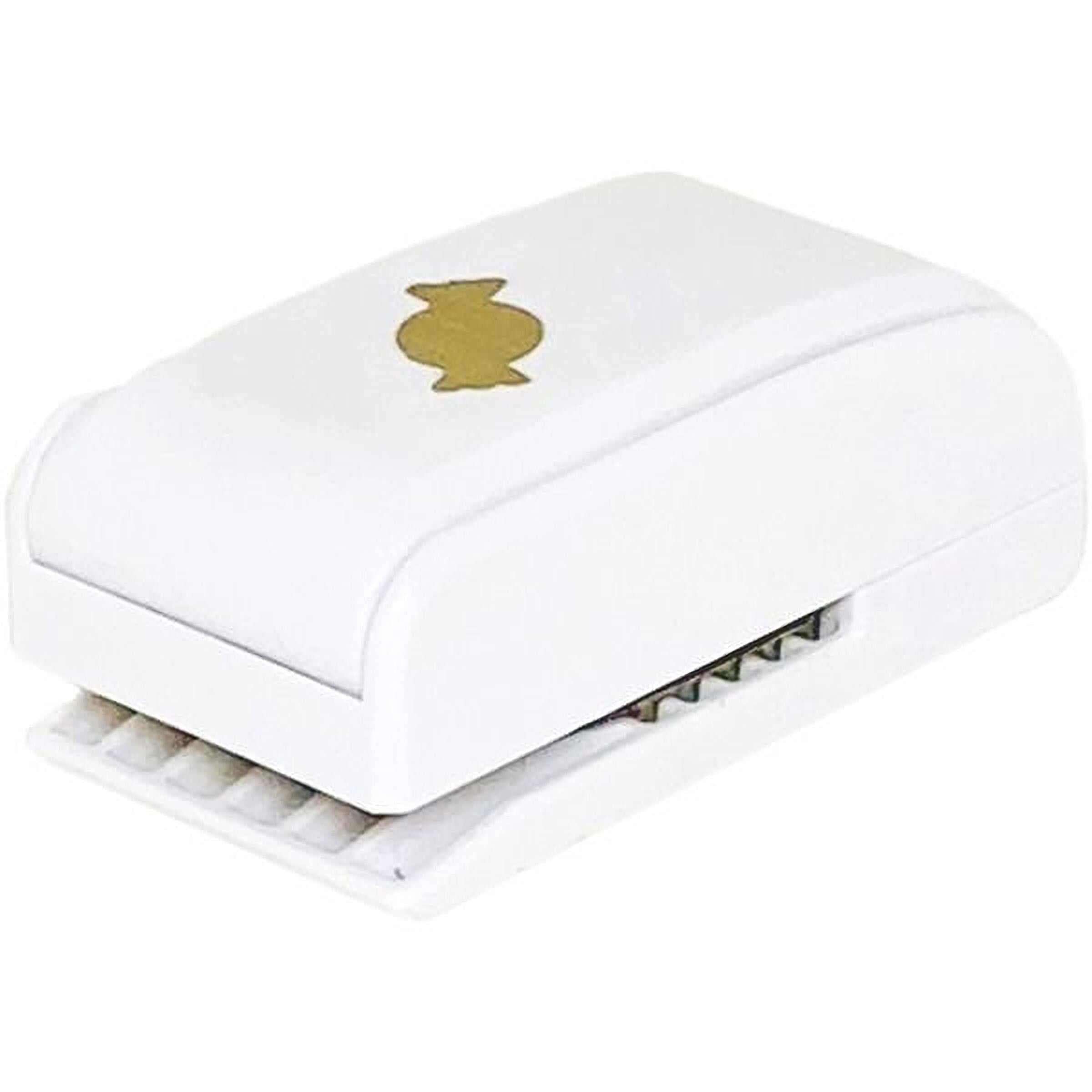 A white plastic stapler with a gold-colored button on the top.