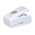 A white plastic hole puncher with a leaf design on it.