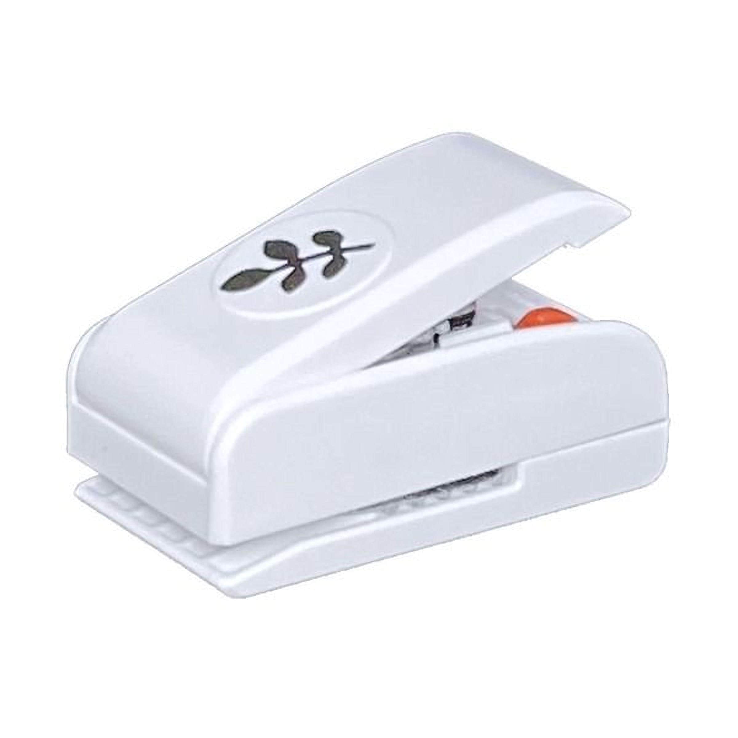 A white plastic hole puncher with a leaf design on it.