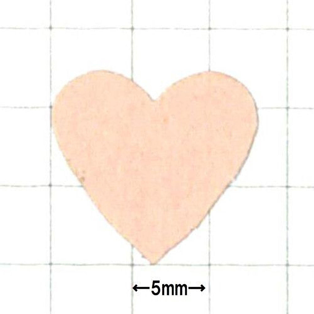 a heart-shaped object, which appears to be a small, light-colored material.