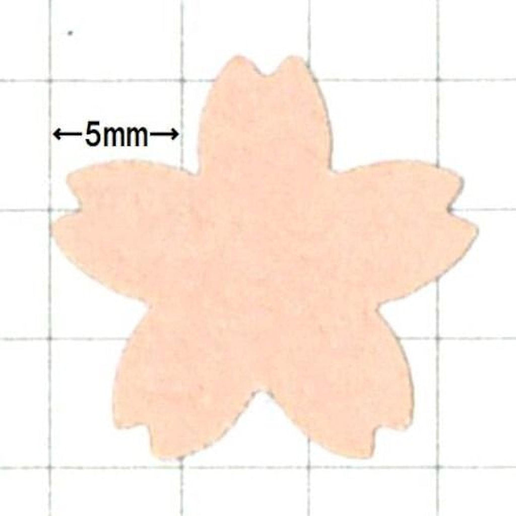 a pink paper flower with a grid background.