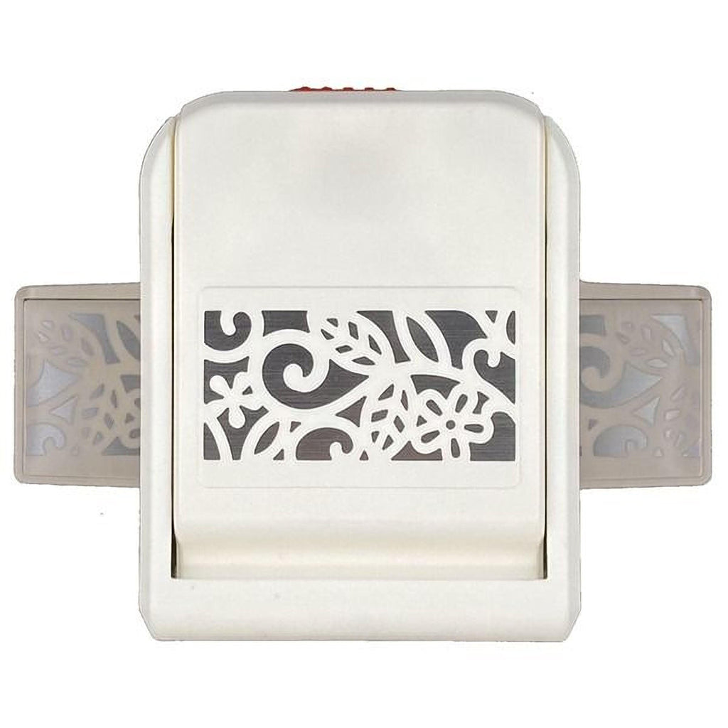 A white, rectangular, and black-and-white patterned punch tool with a red button on the top.