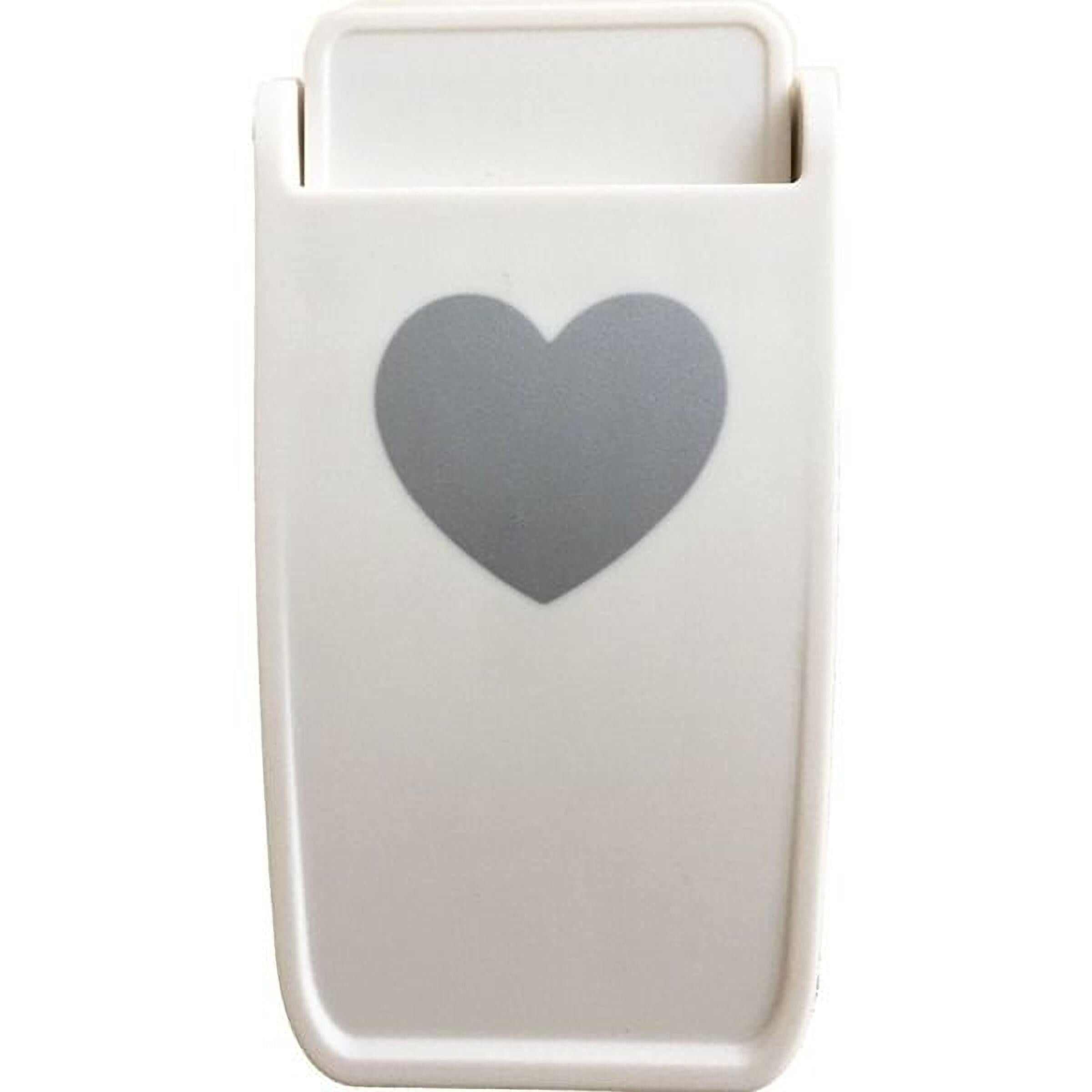 A white plastic object with a heart symbol on it.