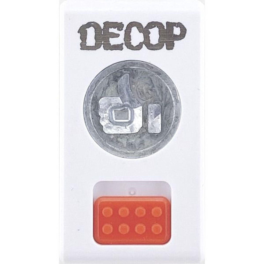 a white rectangular object with a silver coin-like design on the top and an orange Lego-like object on the bottom.