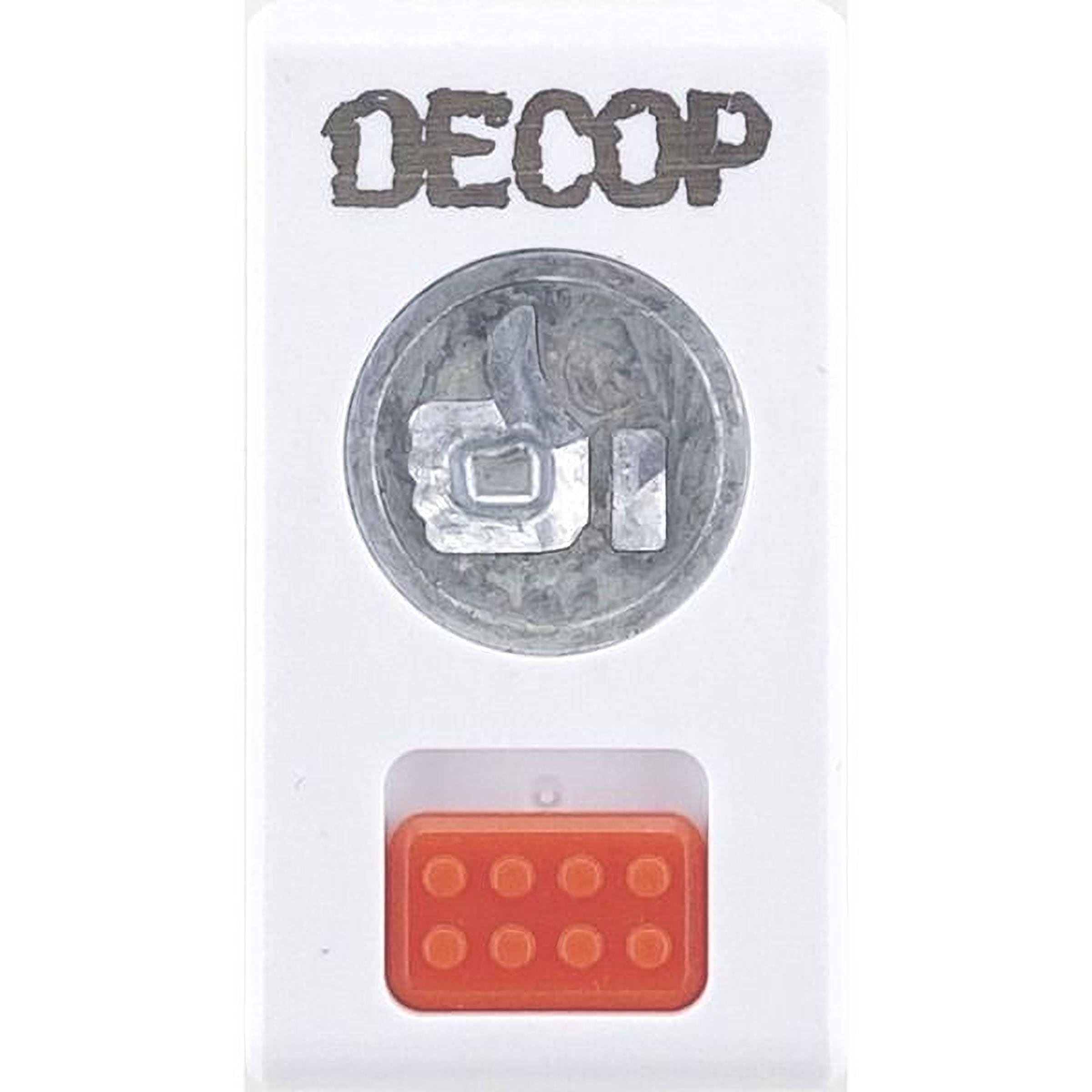 a white rectangular object with a silver coin-like design on the top and an orange Lego-like object on the bottom.
