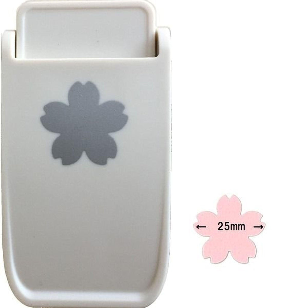A white plastic tool with a gray flower-shaped design on it, along with a smaller pink flower-shaped object that has the size 25mm marked on it.