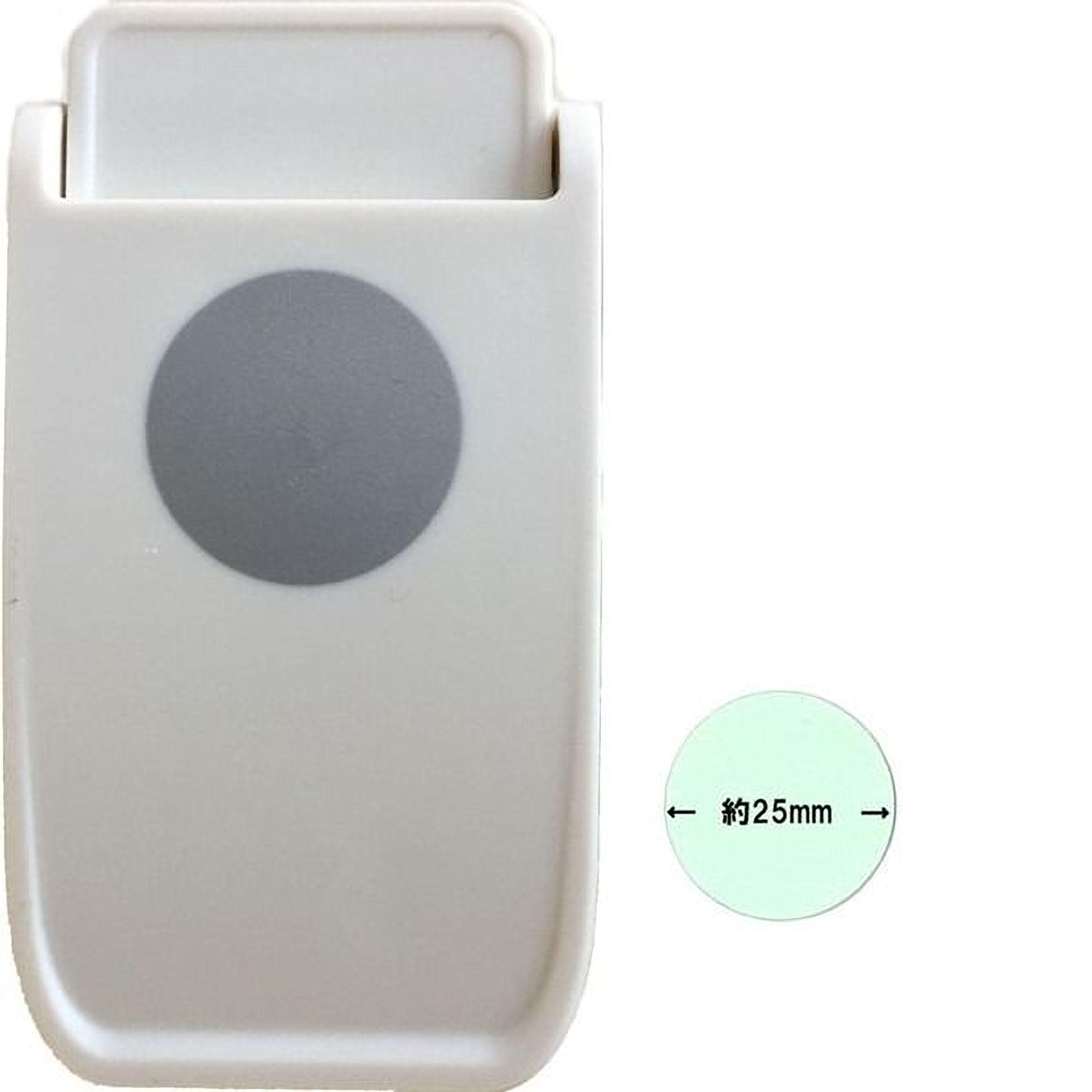a white plastic object with a grey circle on it, and there is a smaller circle with measurements next to it.