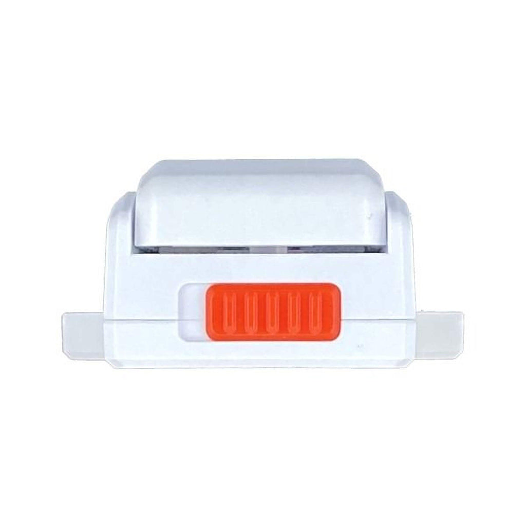 a white and orange object, which appears to be a small, rectangular device with a red button on the front.
