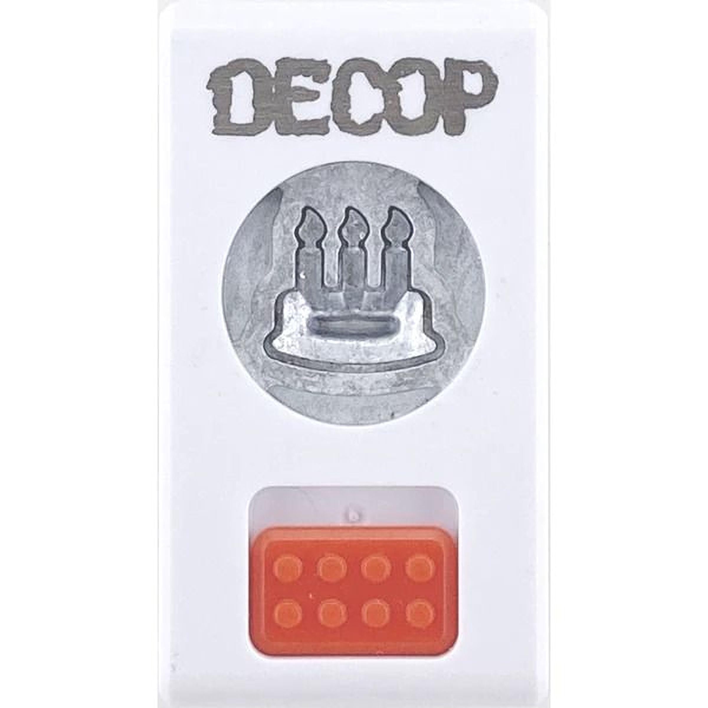 a white plastic object with a silver circular cutout in the center, which appears to be a candle holder. Below the candle holder, there is a red plastic block with a hole in it.