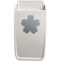 A white plastic object with a silver flower-shaped design on it.