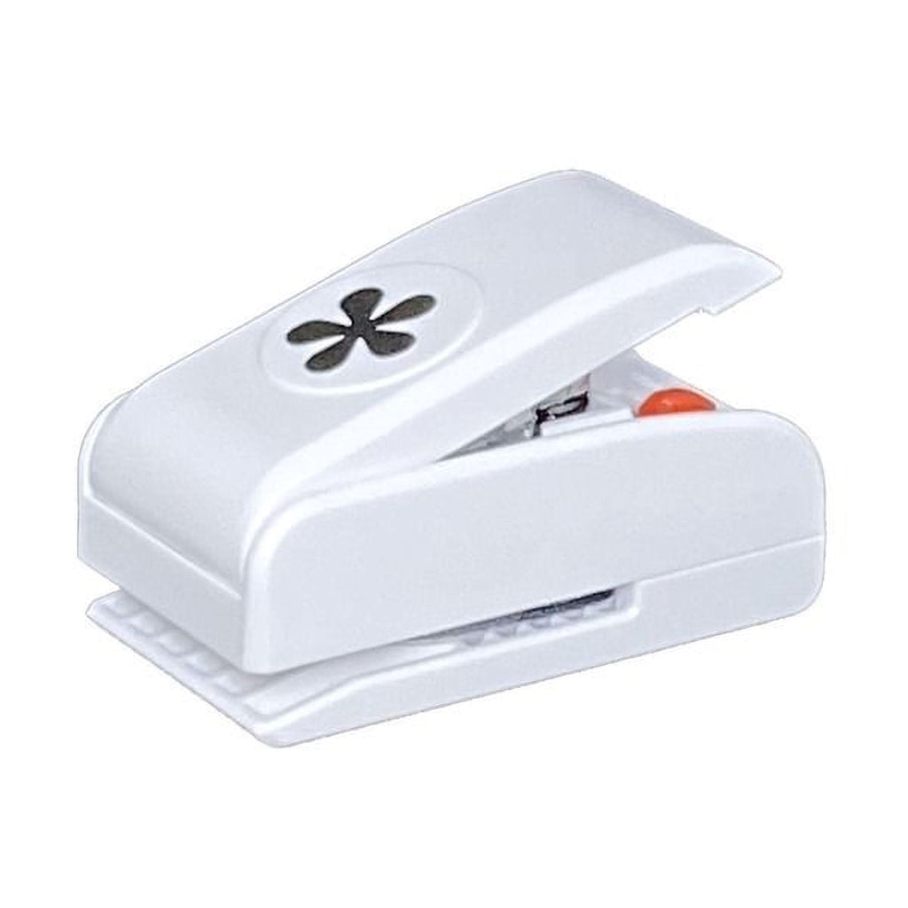 A white plastic hole puncher with a black flower design on the top.