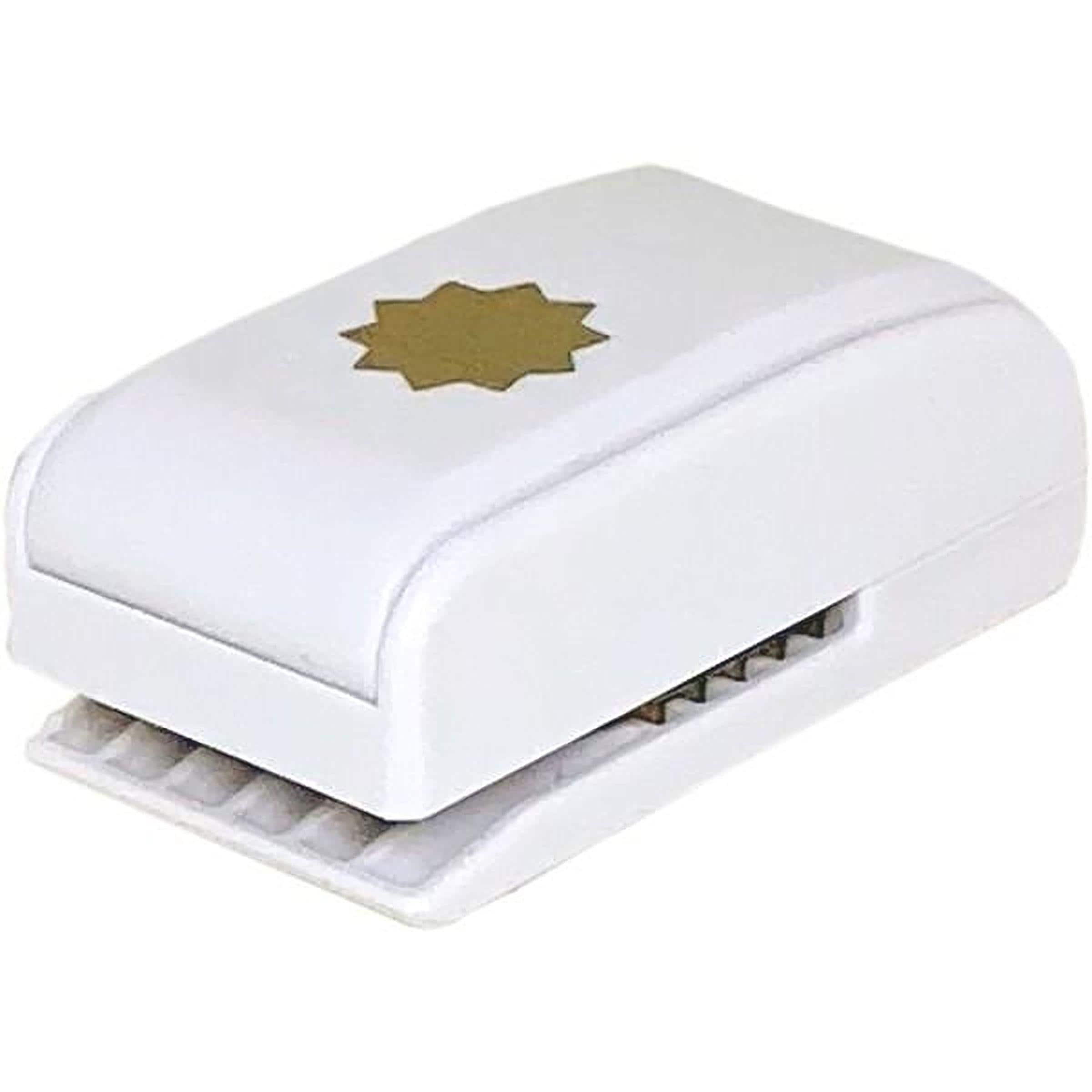 A white, rectangular paper punch with a gold star-shaped design on the top.