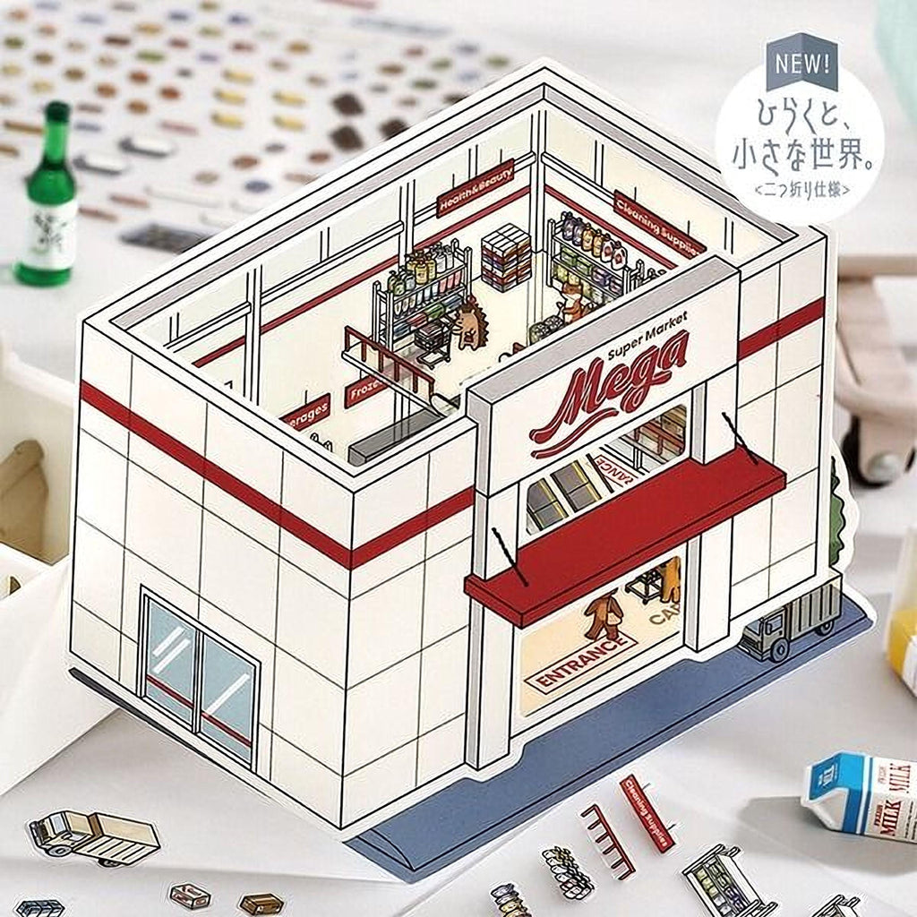 A paper cutout of a grocery store, specifically a Mega store, with various items and a sign indicating it is a new product.