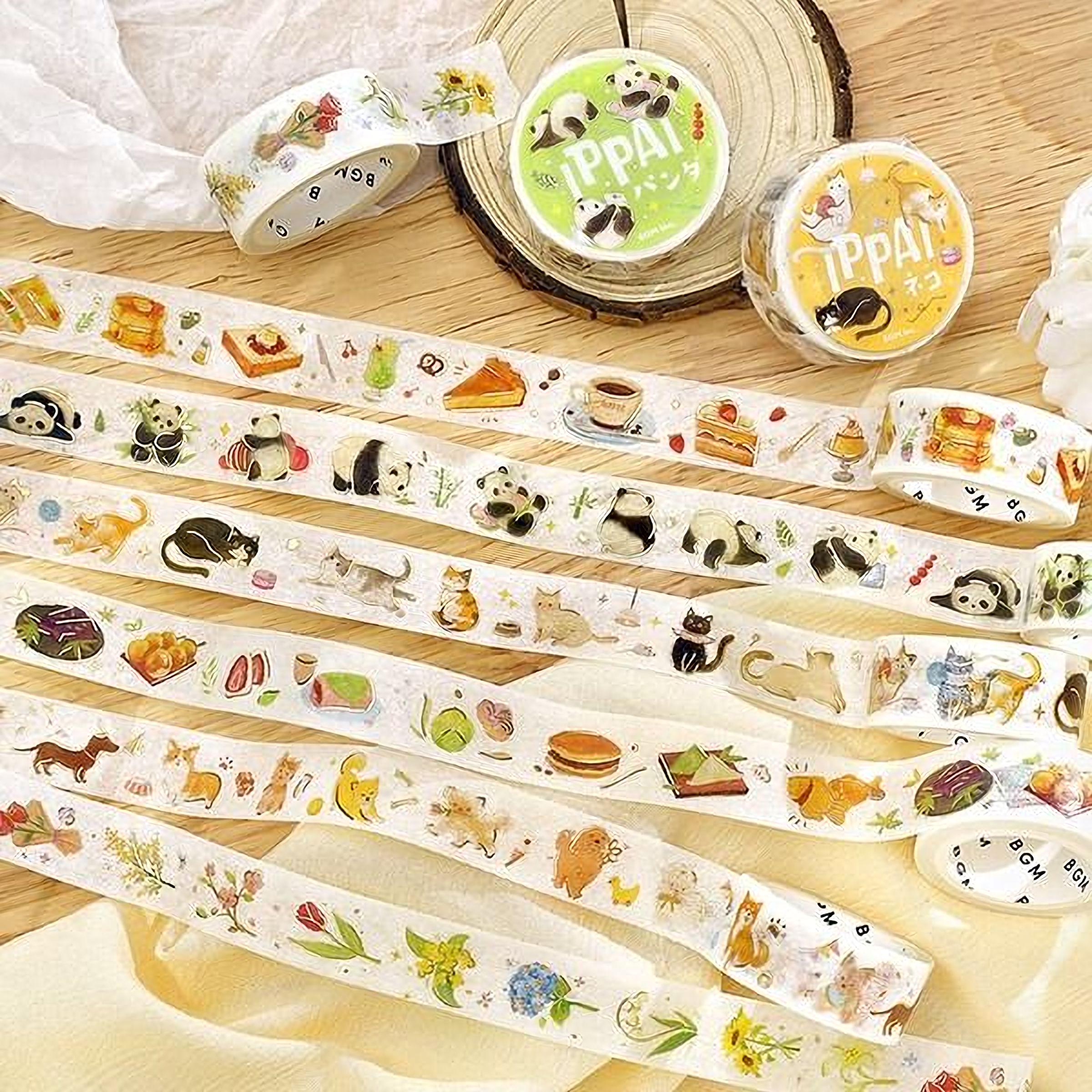 a collection of colorful, patterned, and illustrated tape dispensers arranged on a wooden surface.