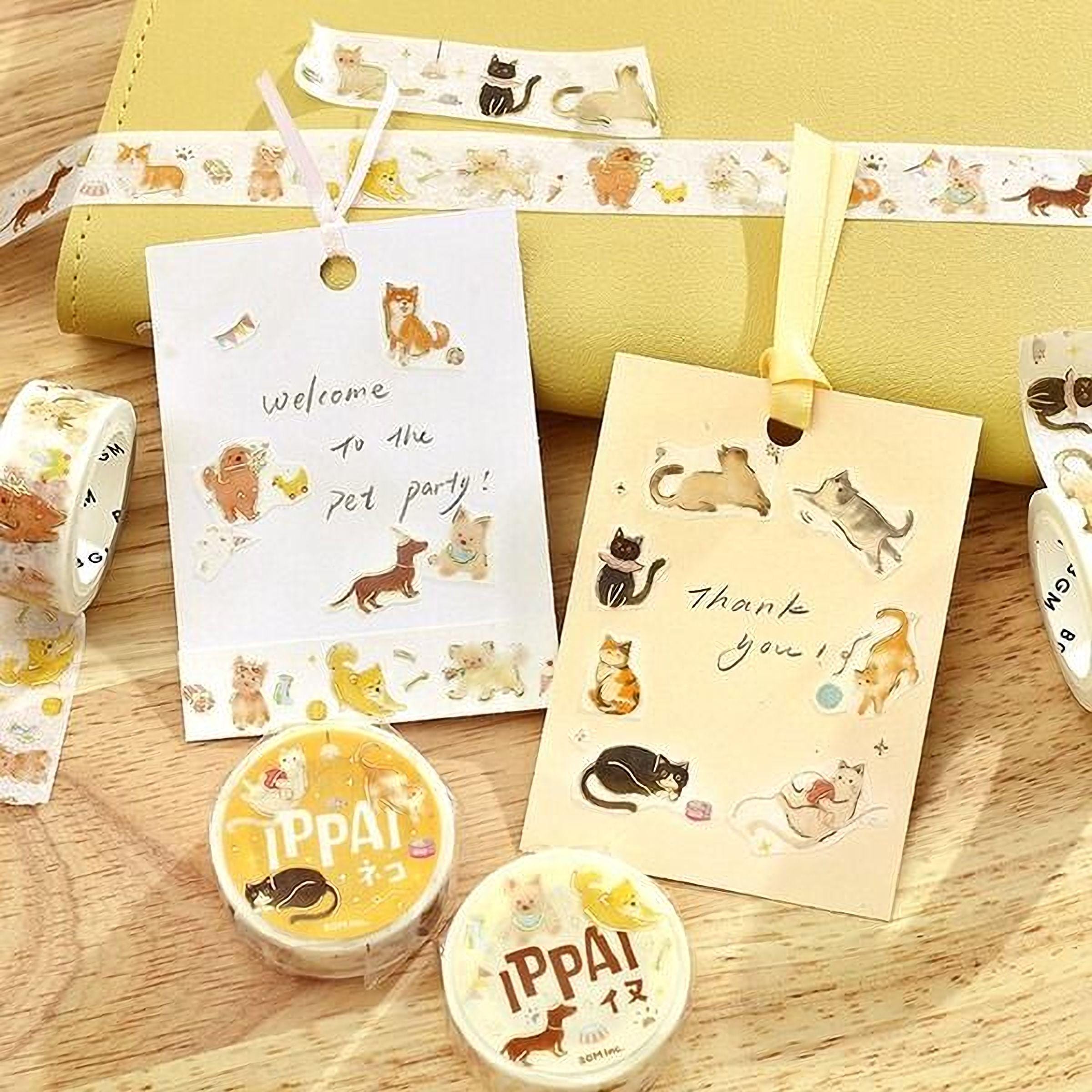 a collection of cat-themed items, including a yellow notebook, a yellow ribbon, and various cat stickers.