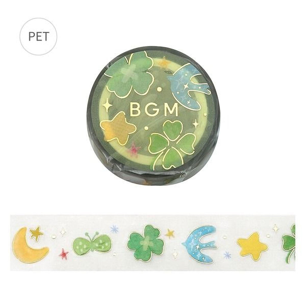 a circular object with a green and yellow design, including various symbols such as a clover, a star, and a butterfly. The object is placed above a decorative border with a repeating pattern of stars, butterflies, and other colorful designs.
