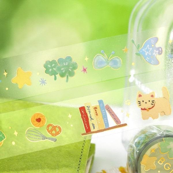 a collection of colorful and whimsical stickers, including a cat, a book, a heart, a star, and a butterfly, all set against a green background.