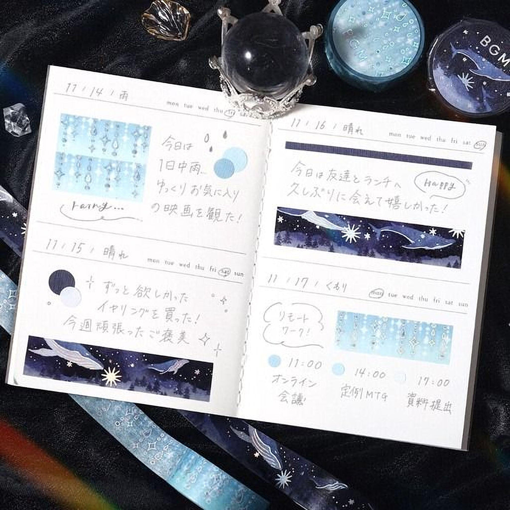 a notebook with handwritten notes and illustrations, along with some decorative elements such as a crystal ball and star-shaped stickers.