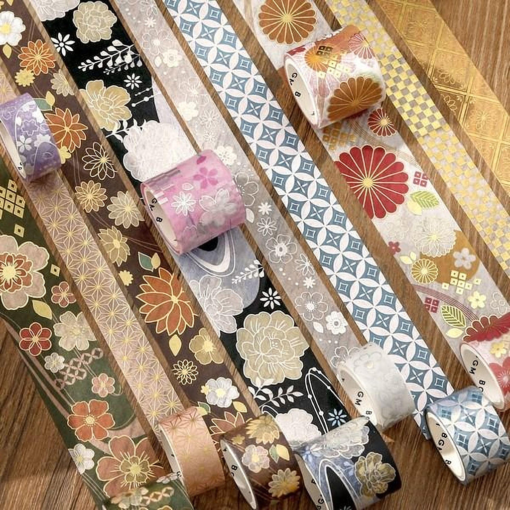 a collection of colorful and patterned washi tape rolls arranged on a wooden surface.