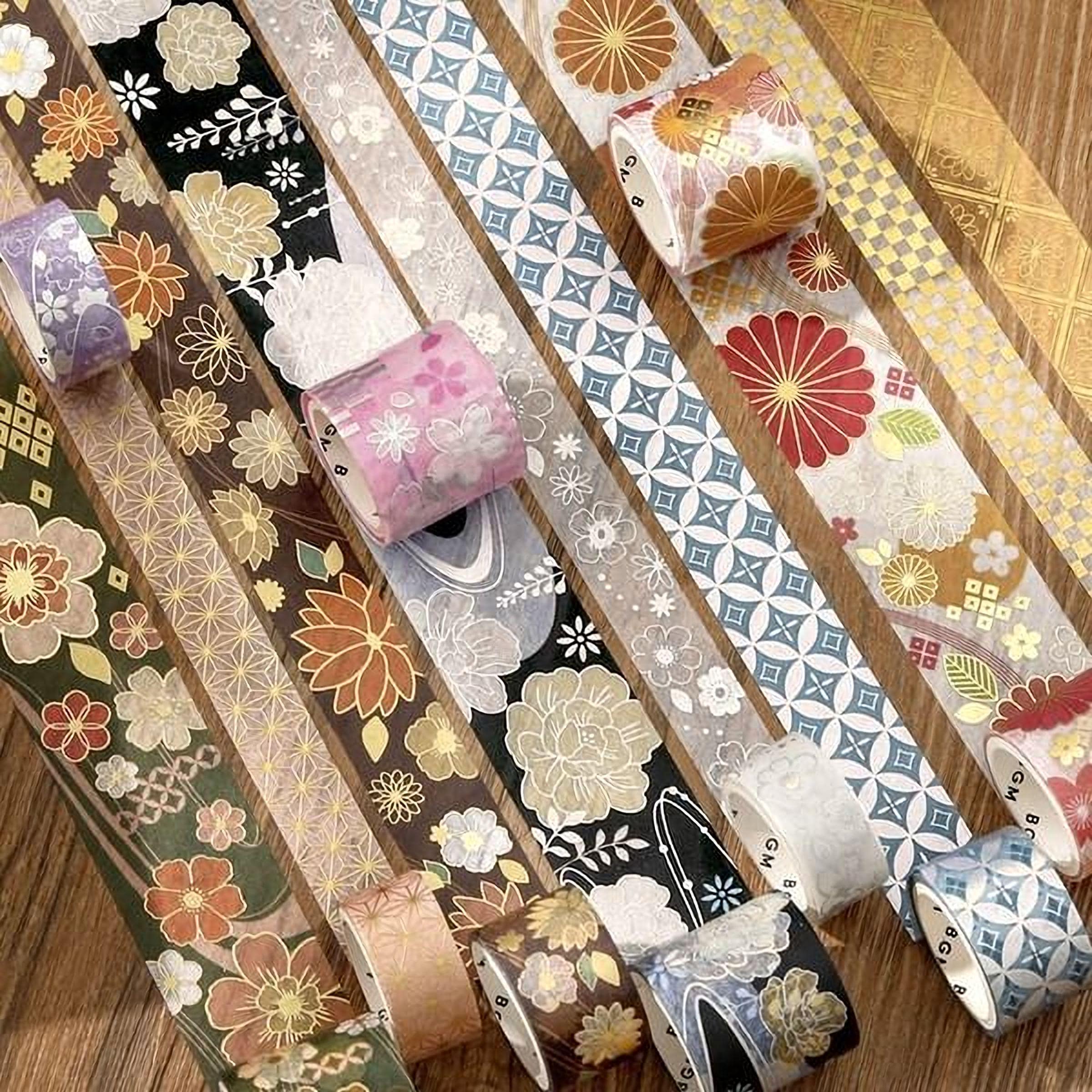 a collection of colorful and patterned washi tape rolls arranged on a wooden surface.