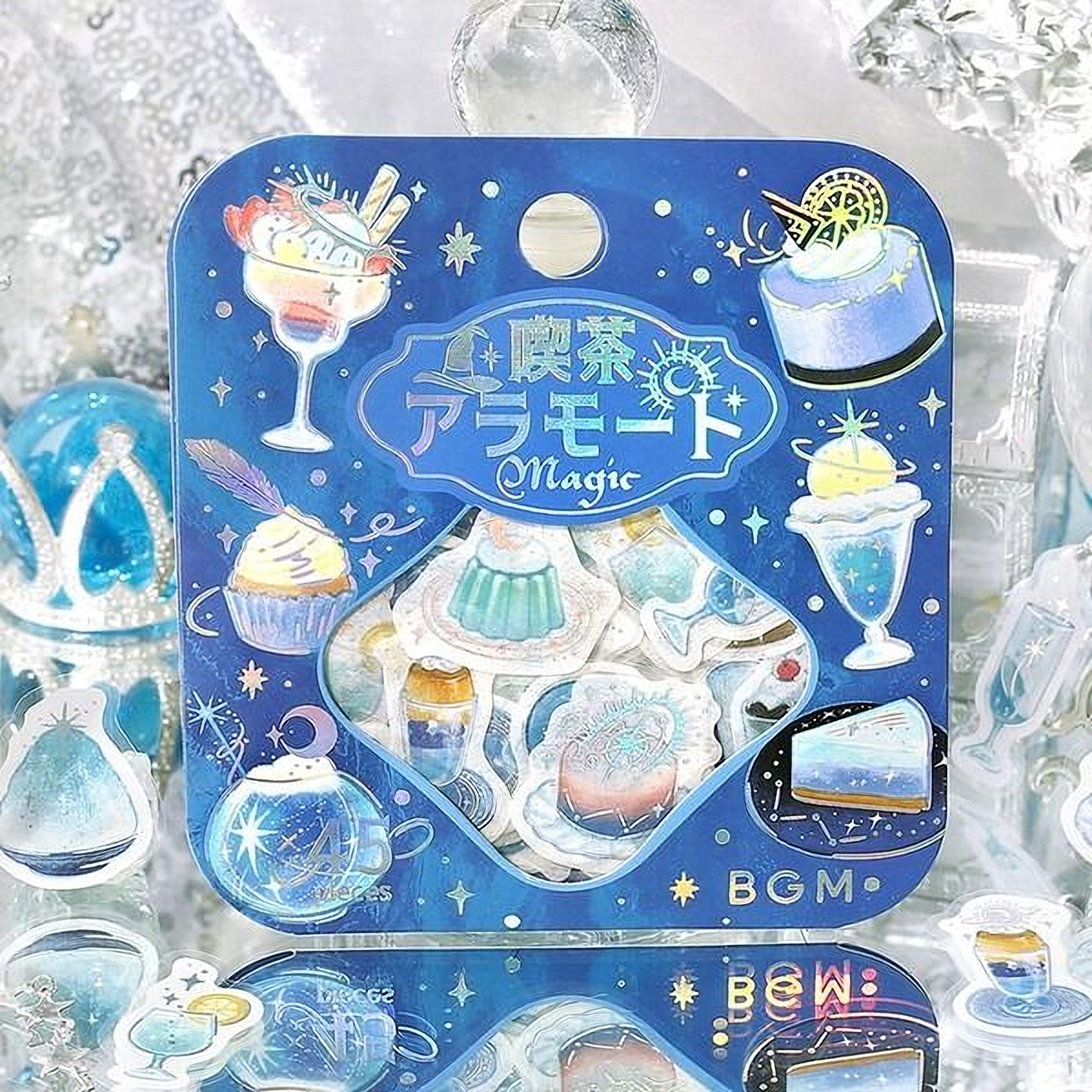 a blue and white box with various desserts and illustrations, including a cake, cupcakes, and a glass of champagne, all set against a snowy background.